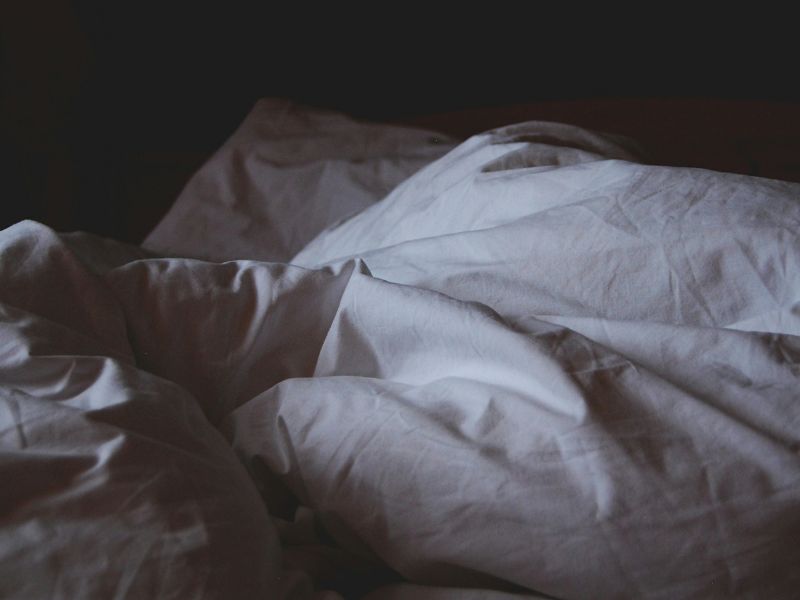white bedsheet on bed