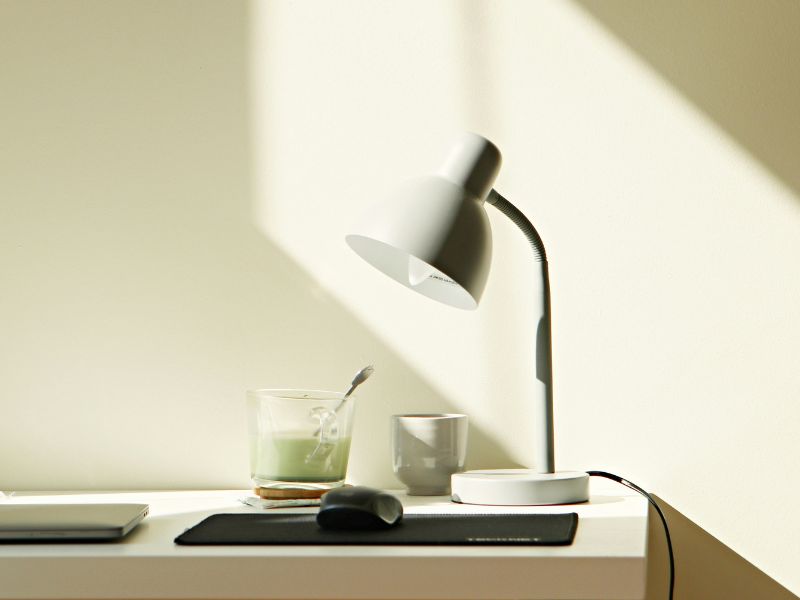 work desk with desk lamp, mouse, laptop, and other stuff